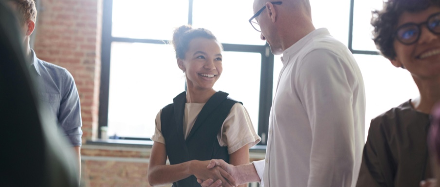 Image of people conversing and smiling.