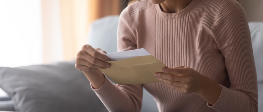 Image of person opening card.