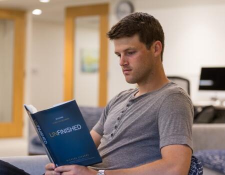 man reading motivational self help book