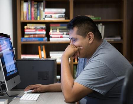 man using iMac in HopeWay library