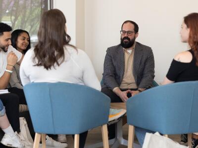 man speaking in group therapy setting