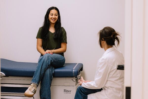teen talking to physician in wellness clinic