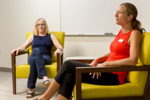 two women sitting in group therapy